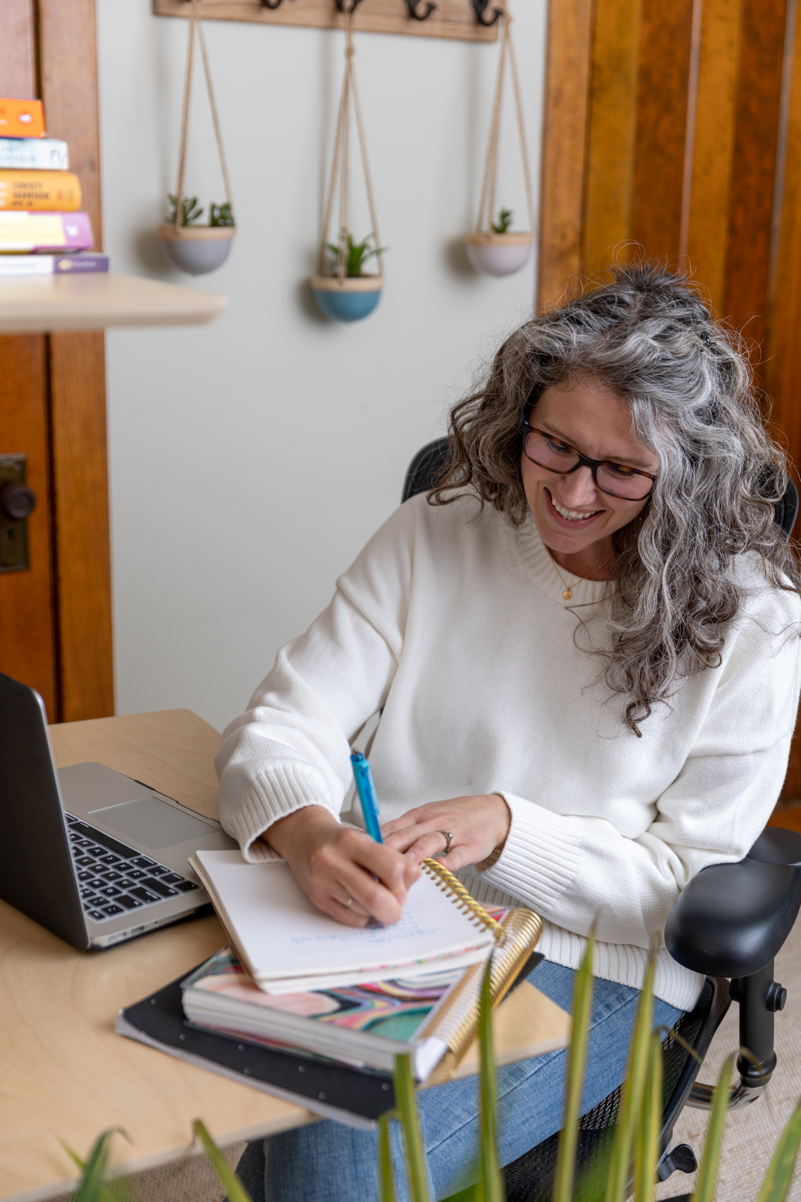 woman taking notes at a desk