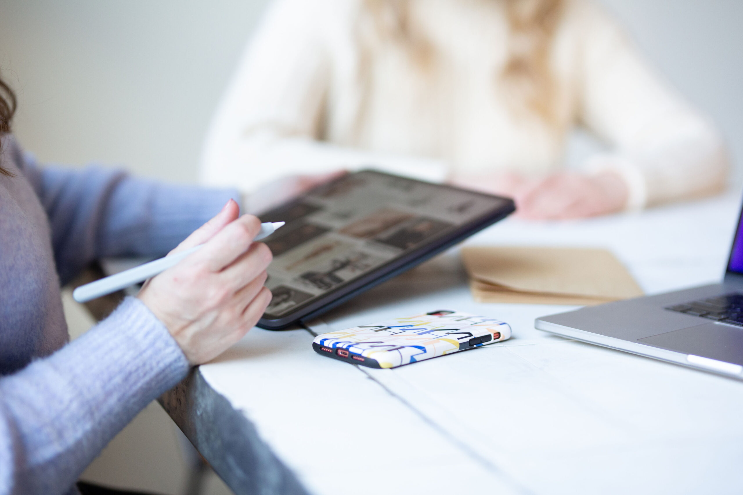 women looking at photos on an ipad