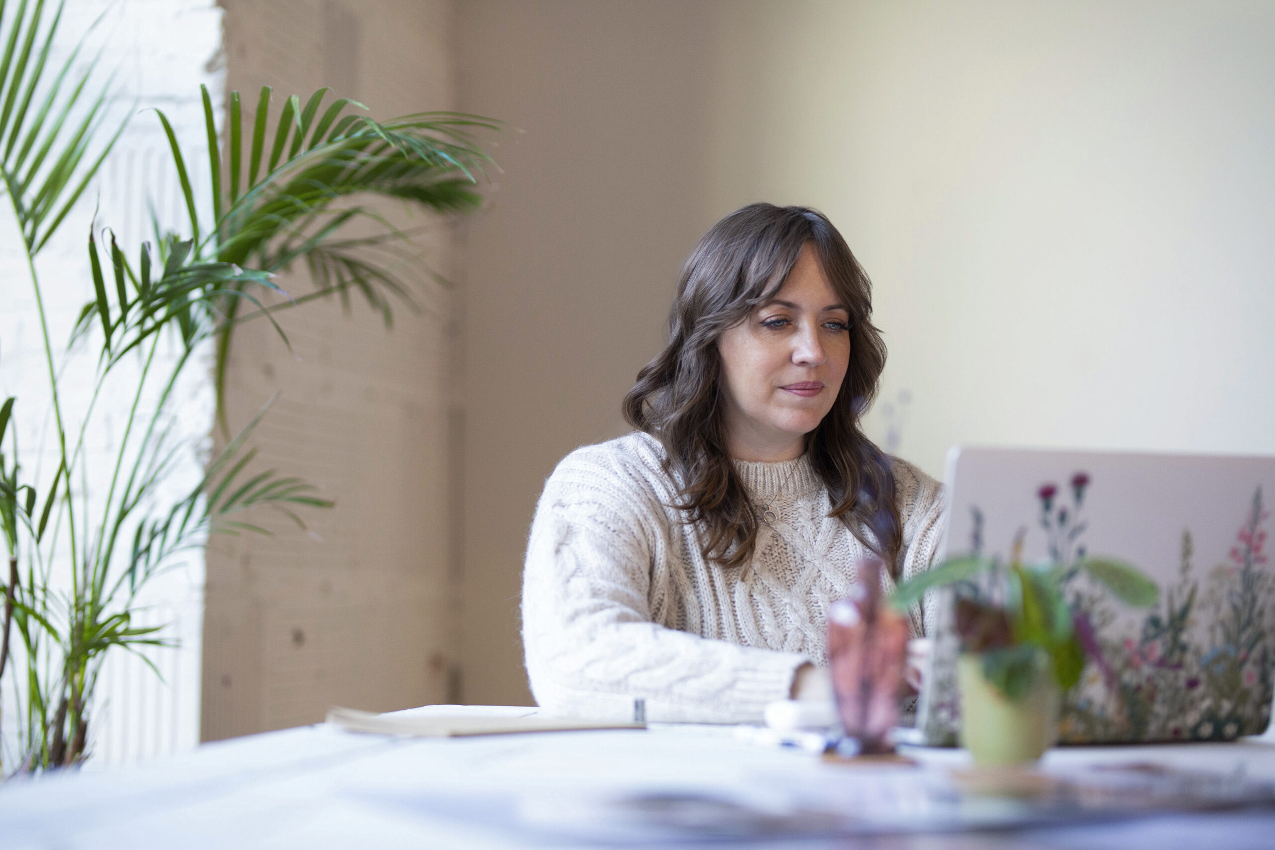 woman sitting at a computer at a table 